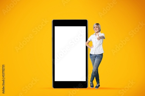 Young woman and a big phone with a blank screen