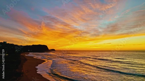 Aerial sunrise with high clouds and gentle sea at Avoca Lagoon and Avoca Beach on the Central Coast, NSW, Australia.