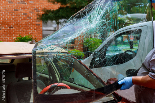 In aftermath an accident near my home, automobile service special workers replaced windscreen