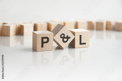 Wallpaper Mural text P and L on wooden blocks with letters on a white background. reflection of the caption on the mirrored surface of the table Torontodigital.ca