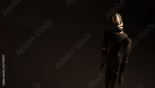 doll with a devilish smile, on a black background, halloween
