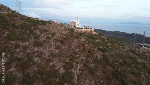 Beautiful view of an old church on a green hill in Dhermi, Albania photo