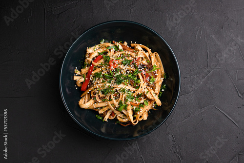 Wok, wok noodles with different fillings on a black background