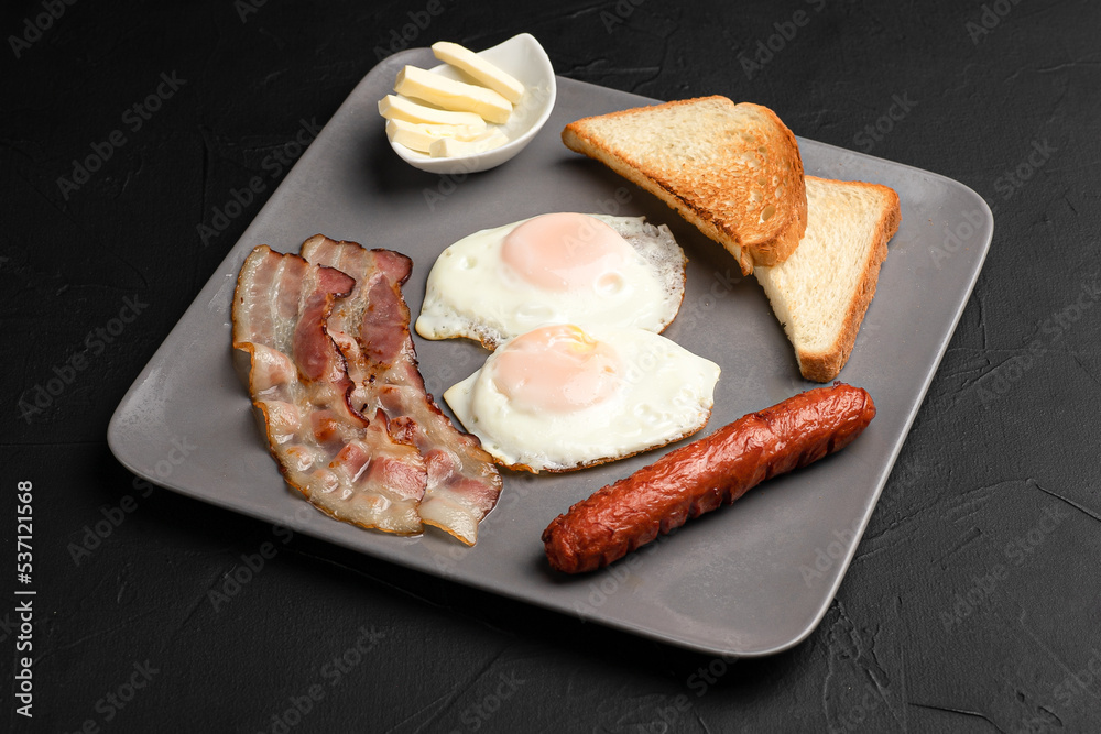 Breakfast, breakfast of eggs, bacon on a black background Breakfast, breakfast of eggs, bacon on a black background