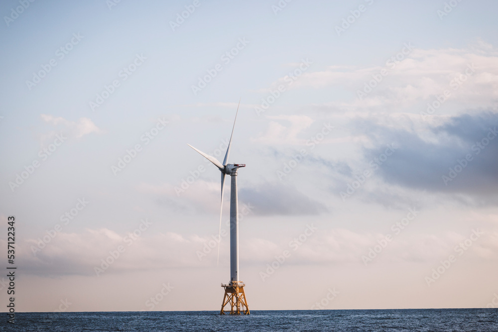 A single renewable energy off shore wind turbine in the ocean
