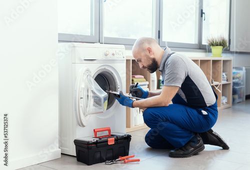 Professional repairman writing an invoice