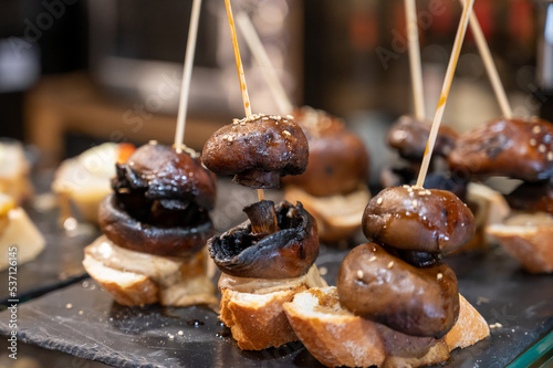 Typical snack is bars of Basque Country and Navarre  pinchos or pinxtos  small slices of bread upon which ingredient or mixture of ingredients is placed and fastened with skewers  San Sebastian  Spain