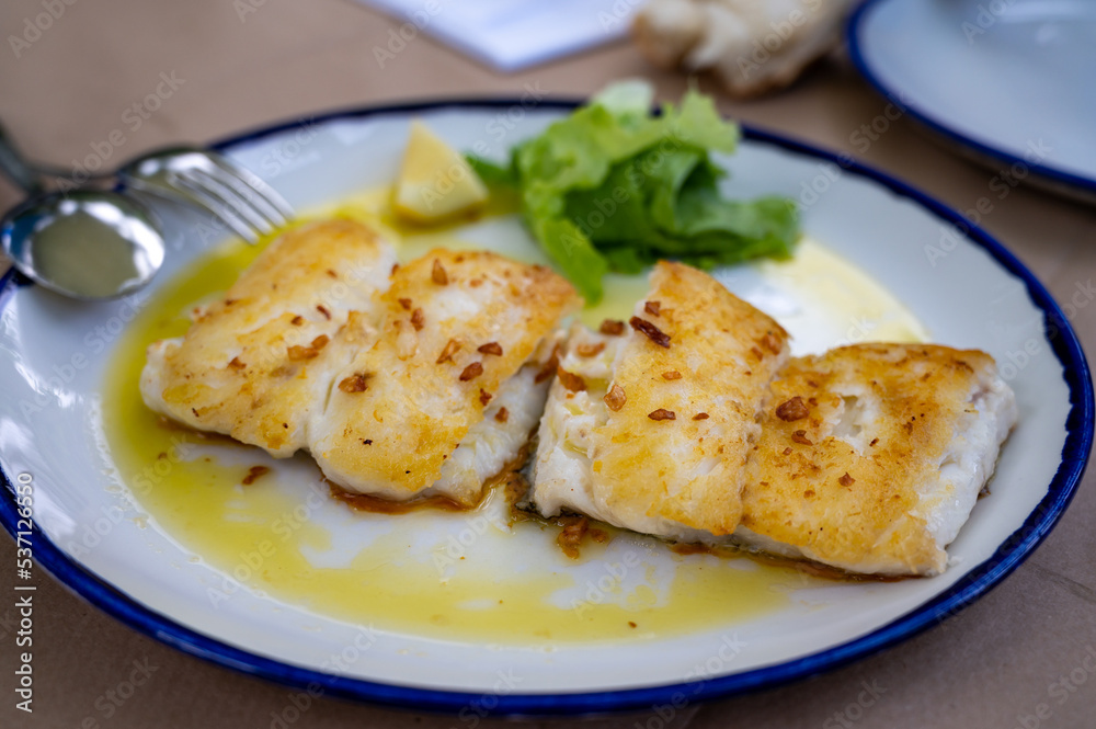 Grilled fillet of white codfish served in fish restaurant in San Sebastian, Basque Country, Spain Grilled fillet of white codfish served in fish restaurant in San Sebastian, Basque Country, Spain