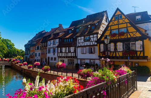 Colorful medieval half-timbered facades reflecting in water, Colmar, France, Alsace