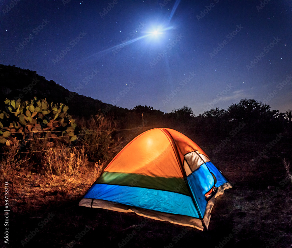 camping tent in field with mountain in the background, night with moon and stars in san miguel de allende guanajuato