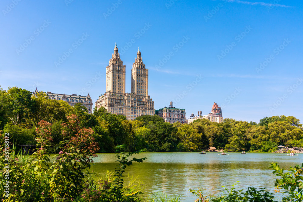 Skyline panorama with Eldorado building and reservoir with boats in Central Park in midtown Manhattan in New York City Skyline panorama with Eldorado building and reservoir with boats in Central Park in midtown Manhattan in New York City