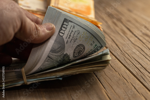 Fotografie wads of money in dollars and Argentine pesos