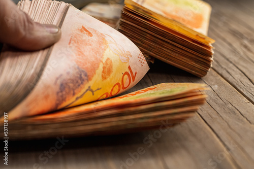 wads of money in dollars and Argentine pesos photo