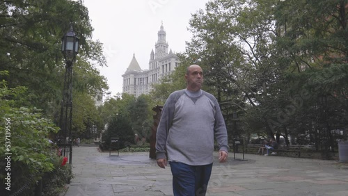 Man walking by Camera New York City with Courthouse behind him 4K
