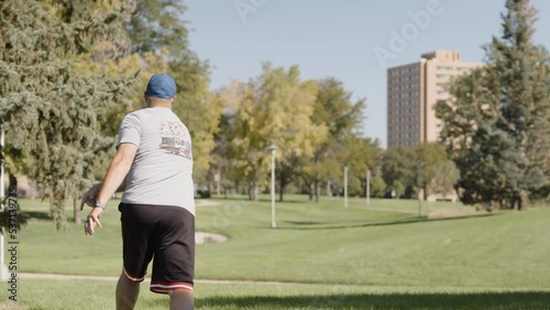 Disc Golf Tee Shot on Discgolf Course in slow motion photo