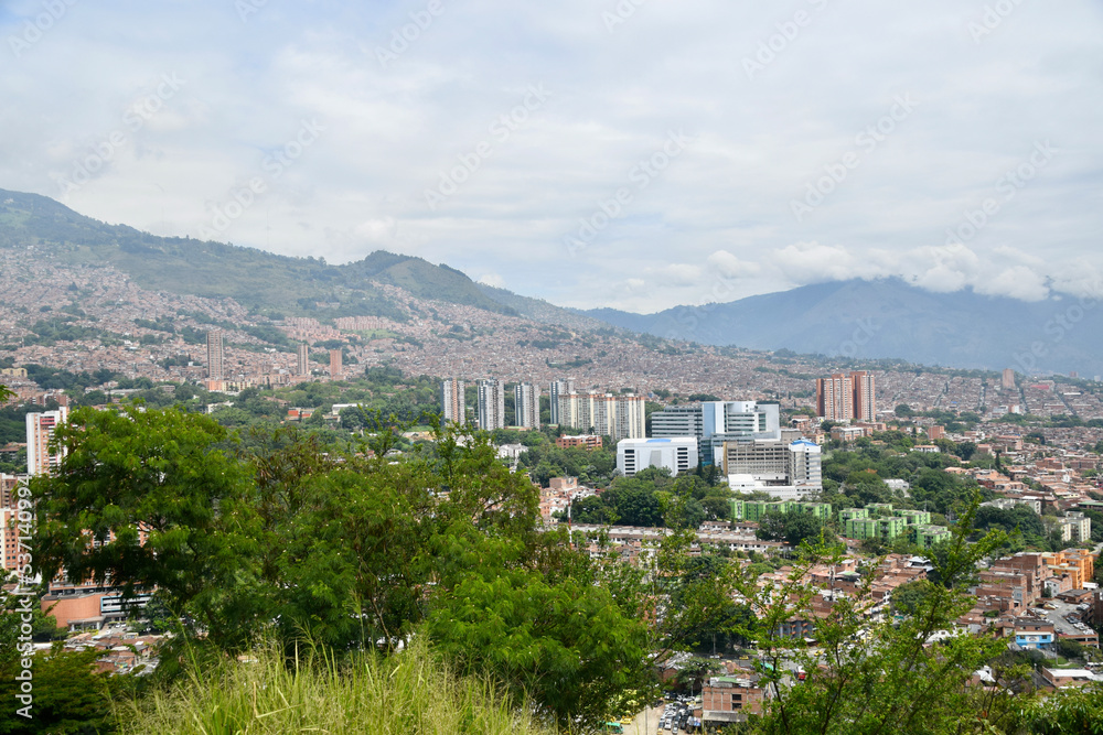 view of city Medellín with mountains, trees, skyscrapers and sky
