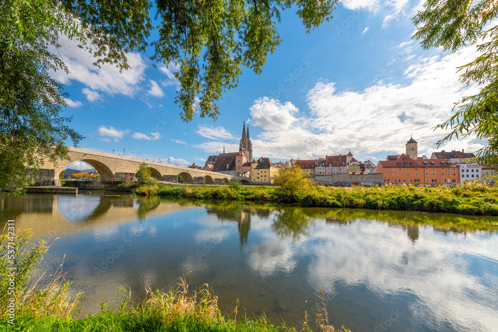 The picturesque skyline including the stone bridge over the Danube River, Saint Peter's Church and Regensburg Town Hall in the Bavarian city of Regensburg, Germany.