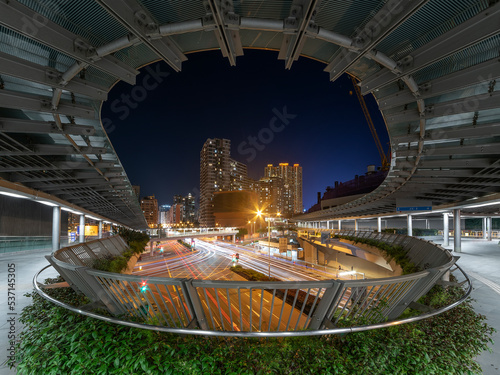 Night scenery of pedestrian walkway and traffic in Hong Kong city
