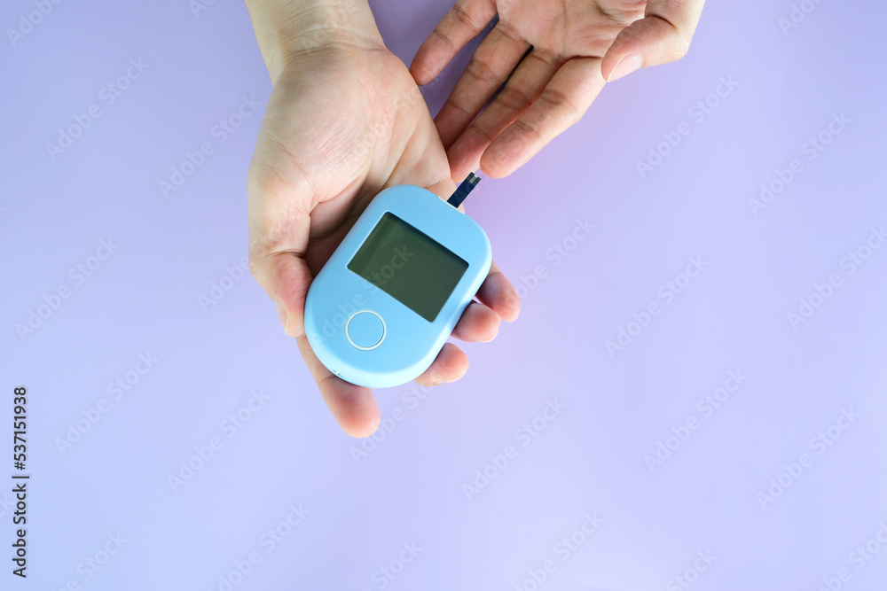 hand of people check diabetes and high blood glucose monitor with digital pressure gauge. Healthcare and Medical concept. hand of people check diabetes and high blood glucose monitor with digital pressure gauge. Healthcare and Medical concept.