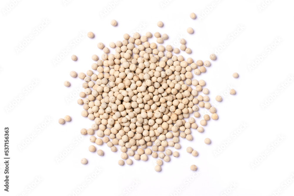 White pepper seeds (peppercorns) isolated on white background, top view, flat lay.