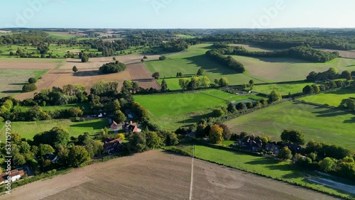 A view of British countryside with a footpath and lush green trees and fields photo