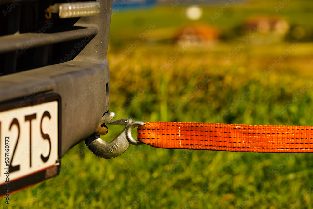 Tow hook with orange strap on car. Towing equipment. Stock Photo