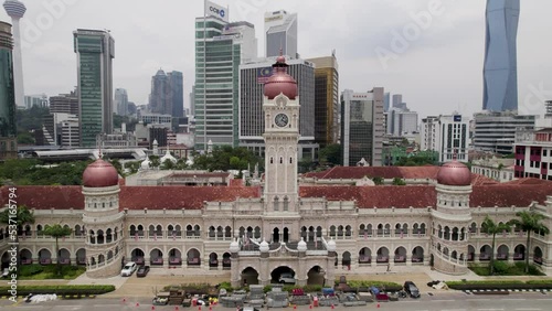 Sultan Abdul Samad Building in Kuala Lumpur, Malaysia. Drone pullback shot with Merdeka Square and city skyline in distance.  photo