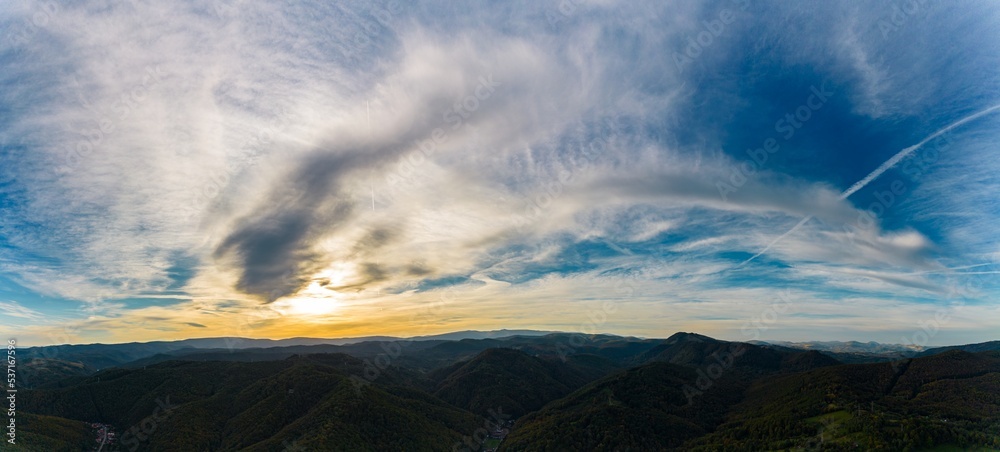 Aerial panorama view of a colorful sunrise in a hilly area near Resita city, Romania. Captured with a drone