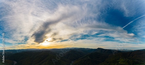 Aerial panorama view of a colorful sunrise in a hilly area near Resita city  Romania. Captured with a drone