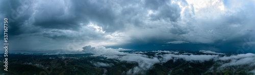 Aerial panorama of foggy hills after a heavy thunderstorm. Panorama captured with a drone in Resita city area, Romania. © Oană Liviu