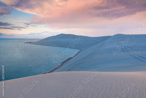 Fototapeta Naklejka Na Ścianę i Meble -  Desert at sunrise, morning glow over dunes inland sea of the Sea line Desert just out of Doha, Qatar.