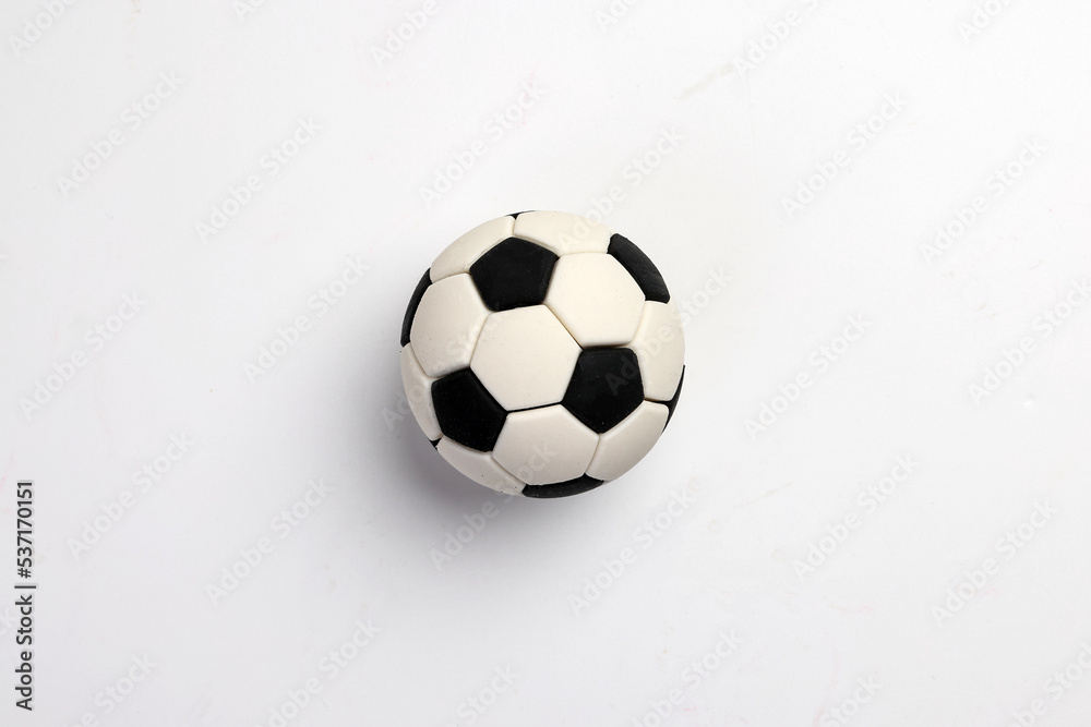 Naklejka premium miniature toy football soccer ball black and white over white background copy text space concept