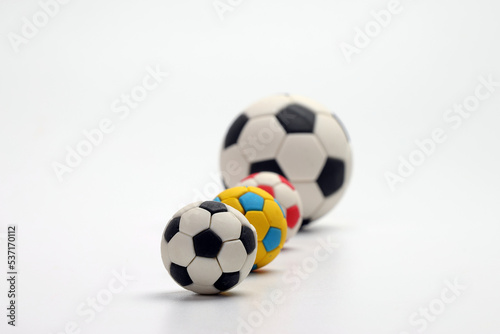 miniature toy football soccer ball black and white colour over white background copy text space concept