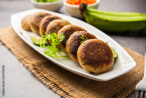 Raw Banana Cutlet also called plantain or kacche kele ki tikki or patties, served with chutney photo