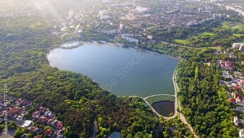 Aerial drone view of Chisinau, Moldova. Valea Morilor park with lush greenery and lake. Residential buildings around photo