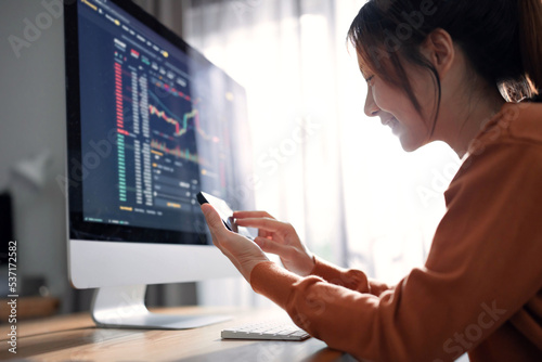 Closeup - Woman is checking Bitcoin price chart on digital exchange on smartphone, cryptocurrency future price action prediction. photo