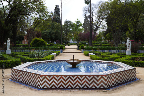 Mediterranean style tiled fountain in a park in Seville.