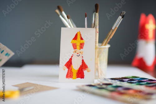 children's drawing - card for day of saint nicholas on table background for traditional Dutch holiday sinterklaas. craft for kids photo