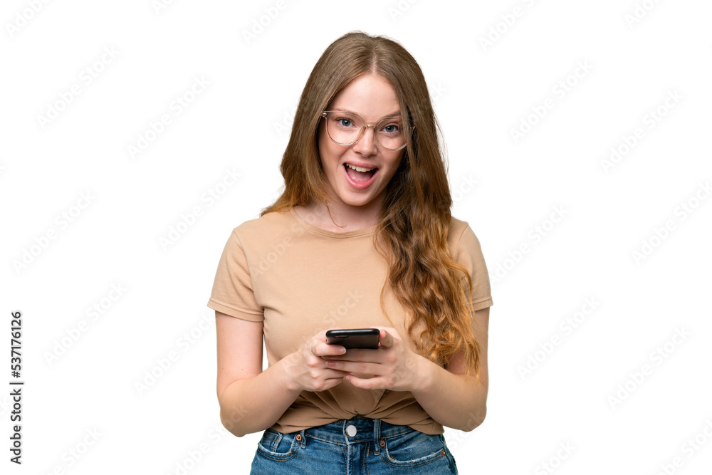 Young pretty woman over isolated background surprised and sending a message Young pretty woman over isolated background surprised and sending a message