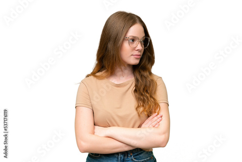 Young pretty woman over isolated background keeping the arms crossed © luismolinero