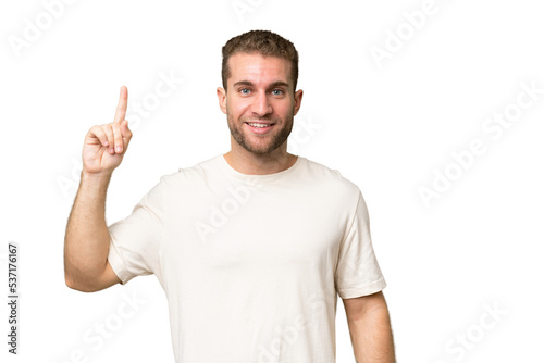 Young handsome caucasian man isolated on green chroma background pointing up a great idea