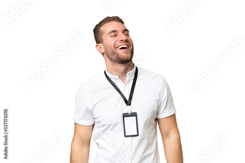 Young caucasian man with ID card isolated on green chroma background laughing