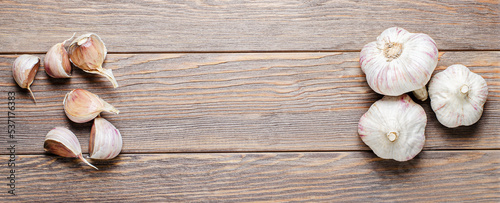 Garlic bulbs on a wooden background. Copy space.