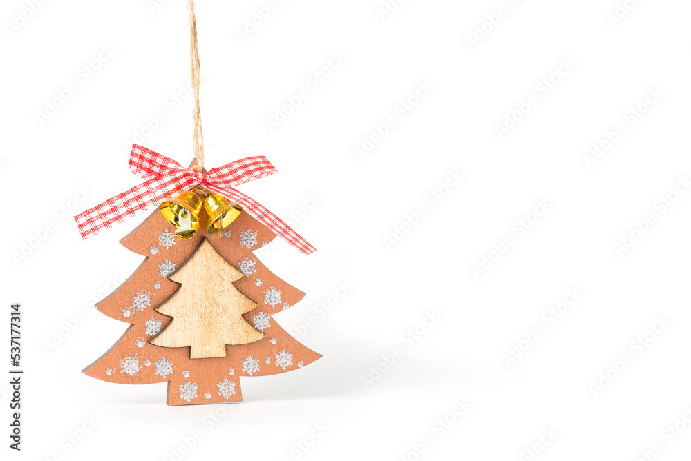 Toy flat wooden Christmas tree with bells and ribbon on a white background. The toy is hanging on a thread. DIY decoration. Front view. Space for text. Toy flat wooden Christmas tree with bells and ribbon on a white background. The toy is hanging on a thread. DIY decoration. Front view. Space for text.