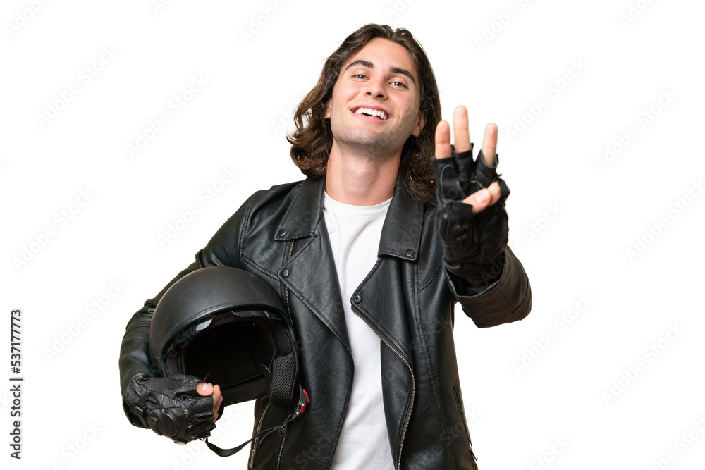 Young handsome man with a motorcycle helmet isolated on green chroma background happy and counting three with fingers Young handsome man with a motorcycle helmet isolated on green chroma background happy and counting three with fingers