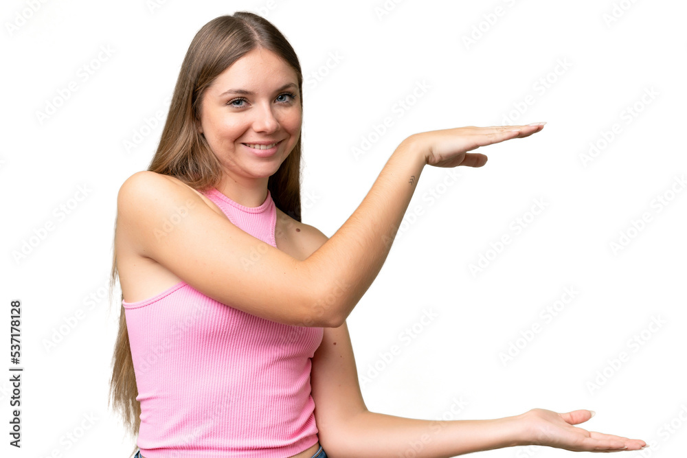 Young beautiful blonde woman over isolated background holding copyspace to insert an ad Young beautiful blonde woman over isolated background holding copyspace to insert an ad