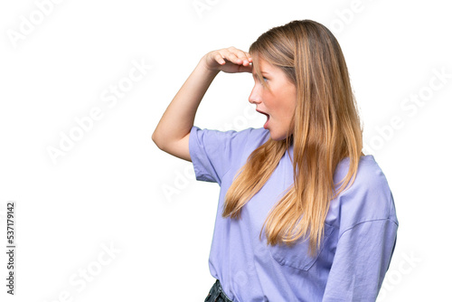 Young beautiful woman over isolated background with surprise expression while looking side © luismolinero