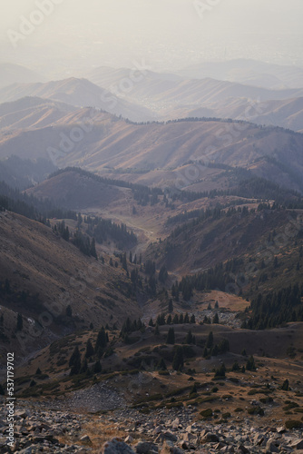 Vertical landscape with a beautiful view of mountain valley at sunset.