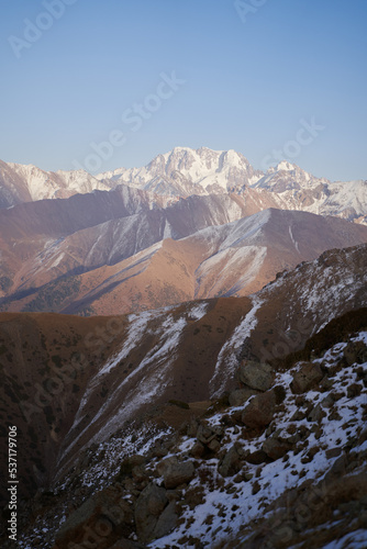Vertical landscape with a view of mountain rocky ridge at sunset.