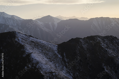 Horizontal landscape with a view of mountain rocky ridge at sunset.